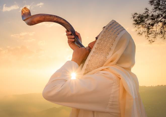 Shofar blowing at sunrise