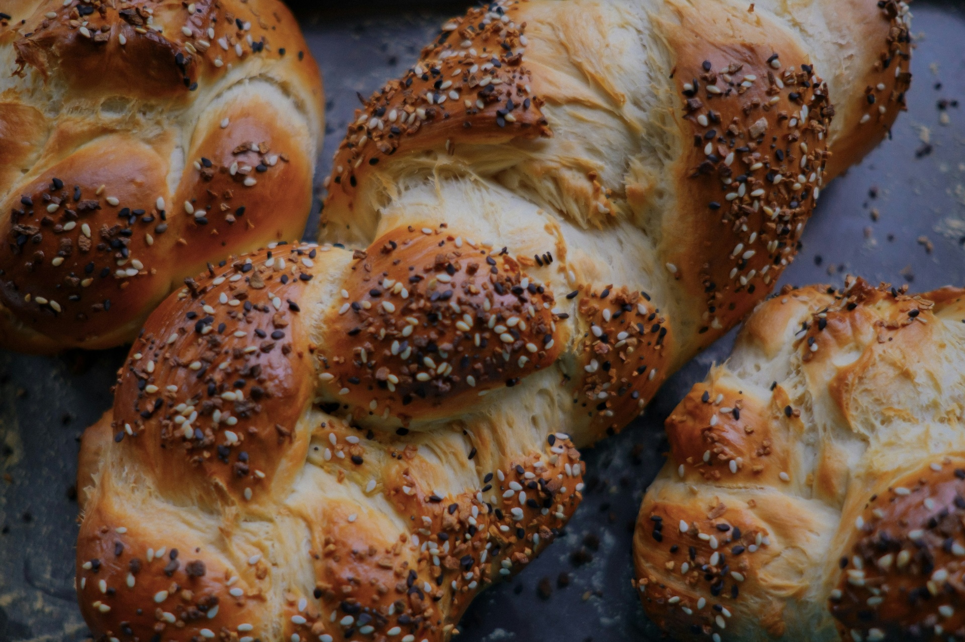 Shabbat lunch table — cholent, challah, friends
